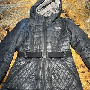 The North Face girls size Large 14-16 Black ski coat with snap belt at waist.